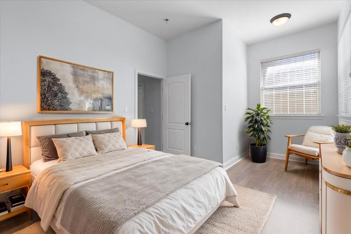 15317 Origins Lane Austin, TX 78734 - Photo 24 of 31 a bedroom with a large bed and a potted plant