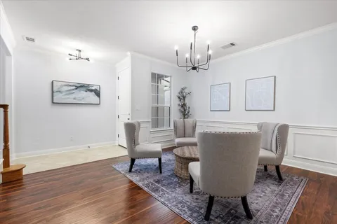 a living room with furniture and a chandelier