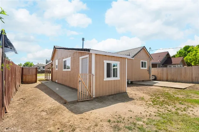 an aerial view of a house with a garden and swimming pool