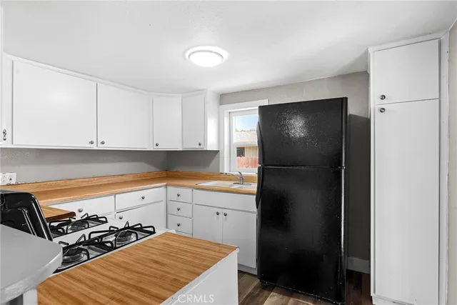 a kitchen with a refrigerator and cabinets