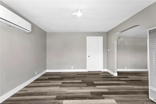 a view of a room with wooden floor and window