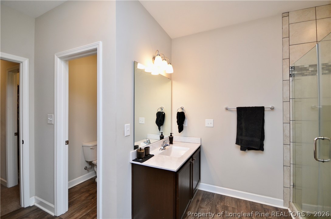 1865 John B Carter Road Fayetteville, NC 28312 - Photo 19 of 49 a bathroom with a sink a toilet and shower