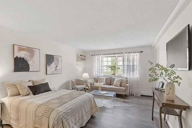 a bedroom with bed and a couch