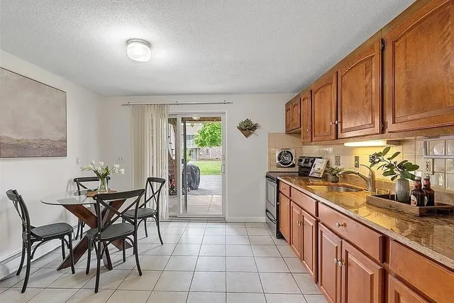 a kitchen with granite countertop a sink and cabinets