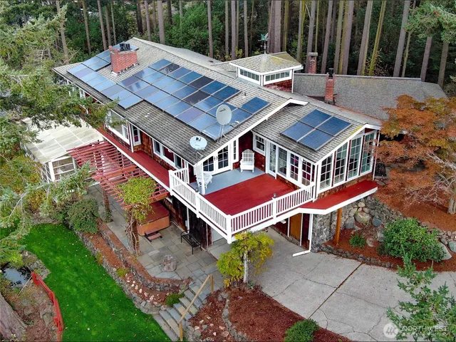 an aerial view of a house with a yard