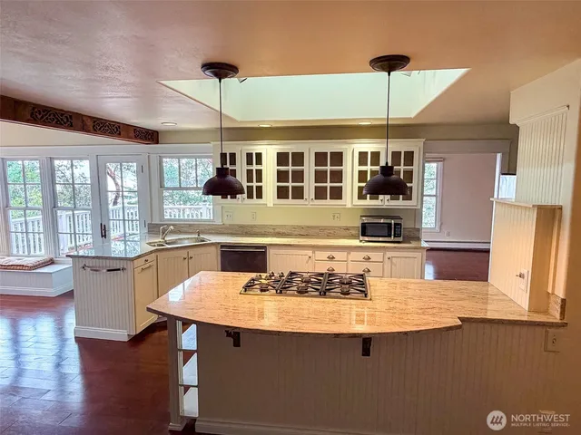 a room with pool table and windows