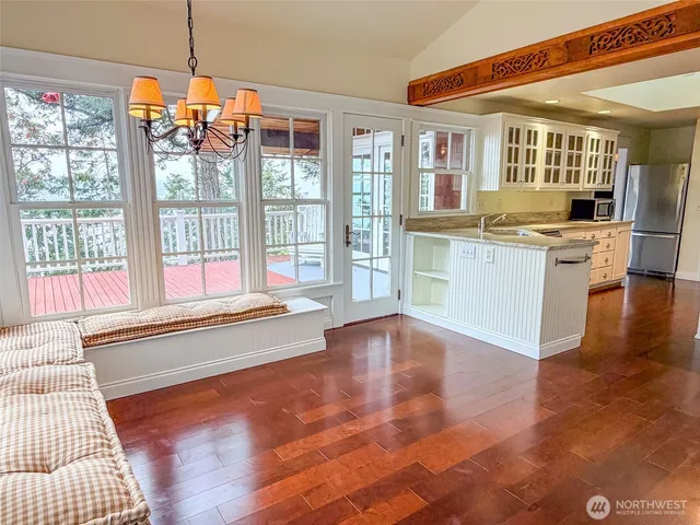 a kitchen with stainless steel appliances granite countertop a sink stove and wooden floor