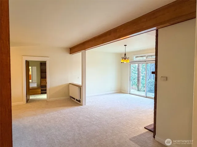 a view of empty room with window and fireplace