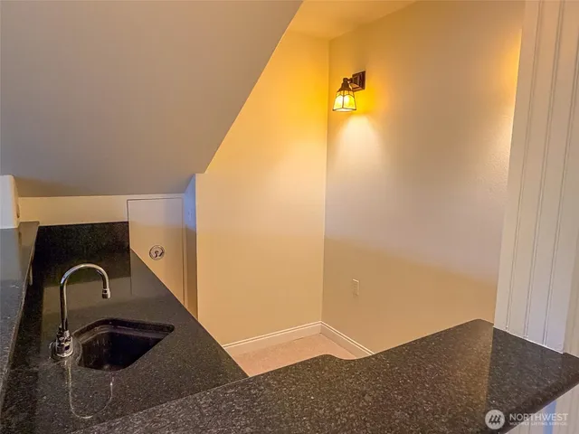 a bathroom with a granite countertop toilet a sink and shower