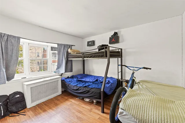 a view of bedroom with furniture and wooden floor