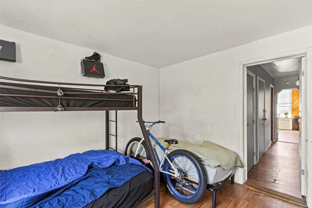 a view of hallway with furniture and wooden floor
