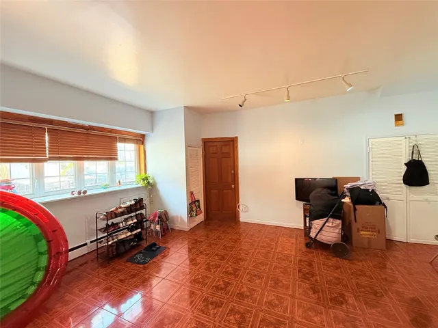 a living room with furniture a wooden floor and next to a window