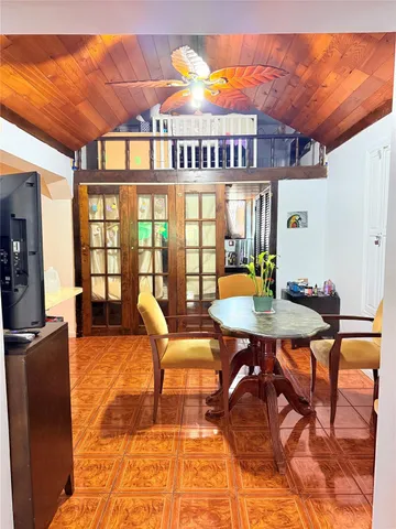 a dining room with furniture window and wooden floor