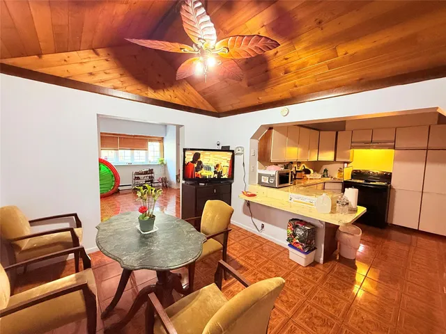 a large white kitchen with a large window