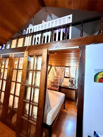 a view of a room with wooden floor