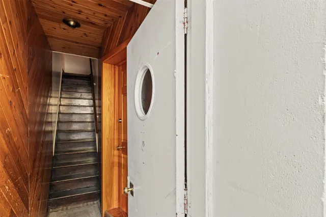 a kitchen with stainless steel appliances granite countertop a stove a sink dishwasher and a refrigerator with wooden cabinets