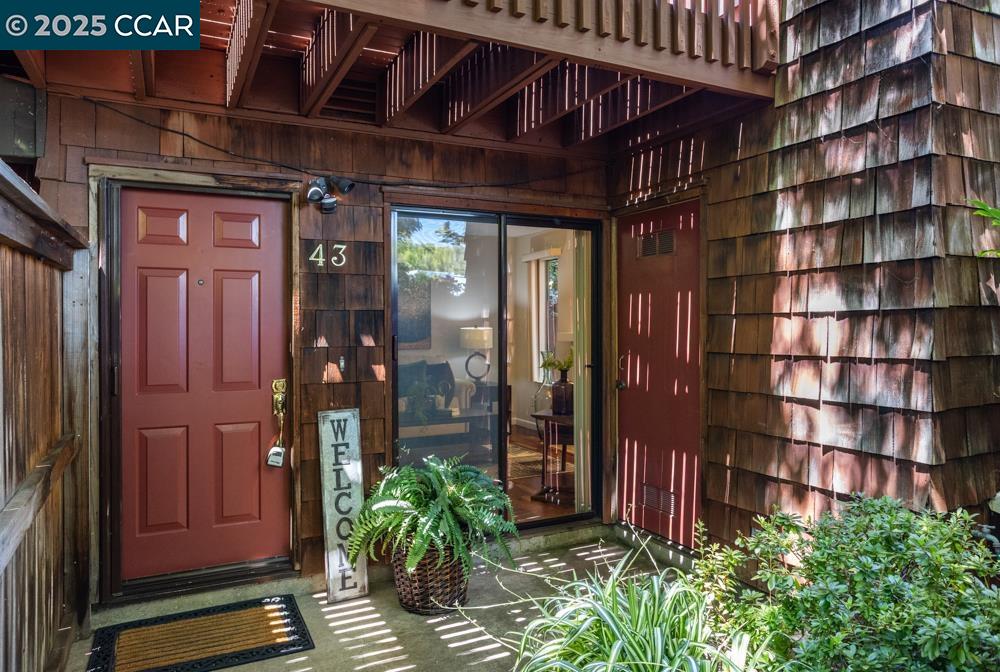 1455 Latour Lane, Unit 43 Concord, CA 94521 - Photo 1 of 17 a view of front door with potted plants
