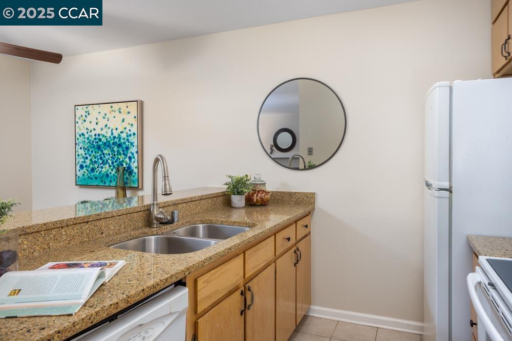 1455 Latour Lane, Unit 43 Concord, CA 94521 - Photo 7 of 17 a bathroom with a granite countertop sink and a mirror