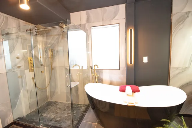 a bathroom with a bathtub and shower