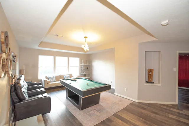 a living room with furniture and a chandelier