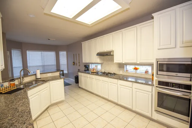 a kitchen with a sink stove and cabinets