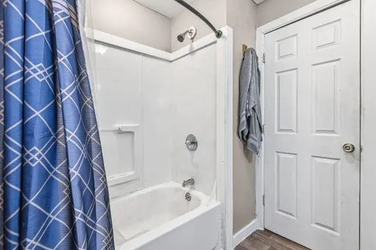 a bathroom with a bathtub and a shower