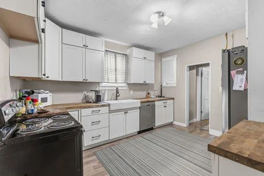 a kitchen with a sink stove and refrigerator