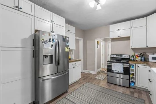 a kitchen with stainless steel appliances a refrigerator sink and cabinets