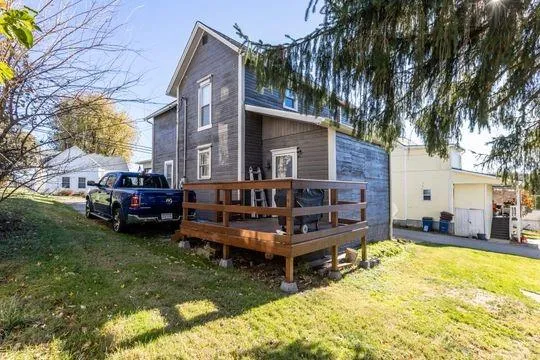 a view of a house with a big yard and sitting area
