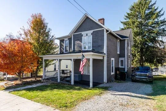 a view of a house with tub next to a yard