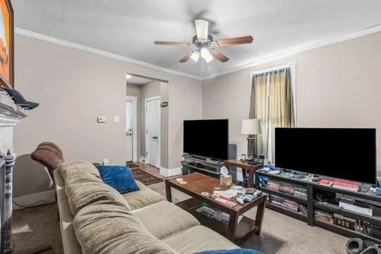 a living room with furniture and a flat screen tv
