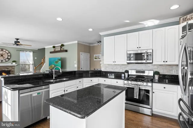 a kitchen with a sink stove top oven and cabinets