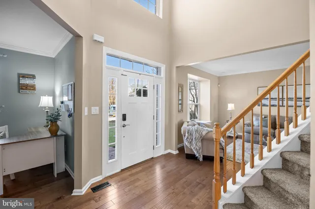 a view of entryway with wooden floor and stairs