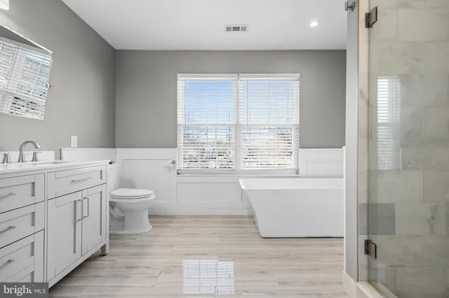 a bathroom with a bathtub and a window