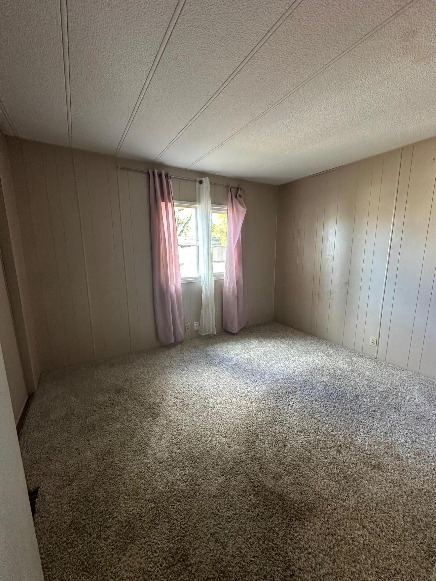 421 Stevens Road, Unit 52 Eagle Point, OR 97524 - Photo 13 of 18 an empty room with windows and brick walls