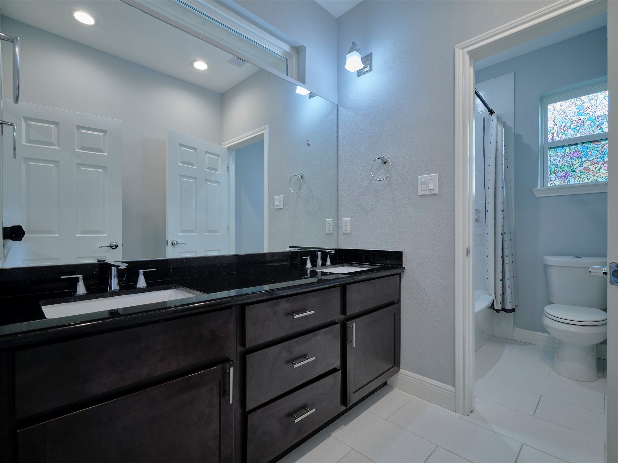 4219 Redbud Street Houston, TX 77051 - Photo 9 of 25 Experience luxury in the primary bath featuring a sleek double vanity, spacious walk-in shower, and a relaxing tub, all set in a modern, elegant design.