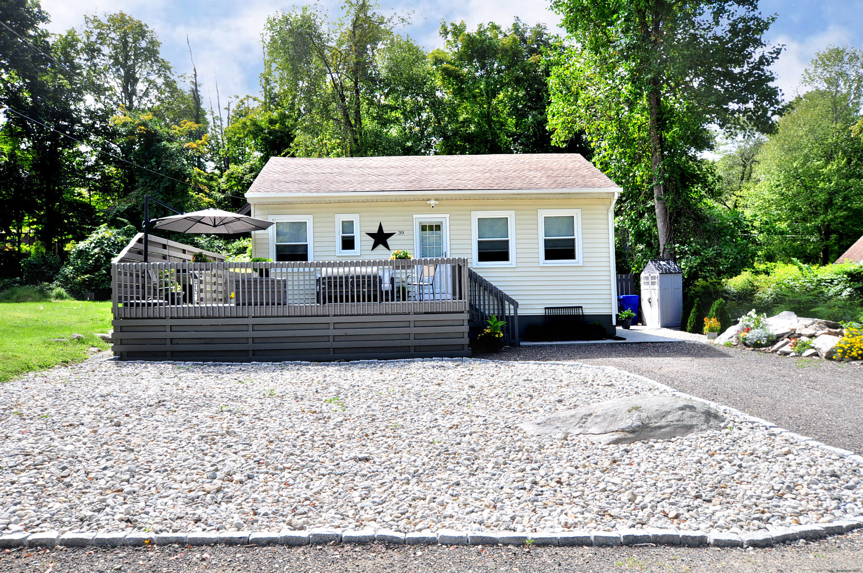 a front view of a house with garden