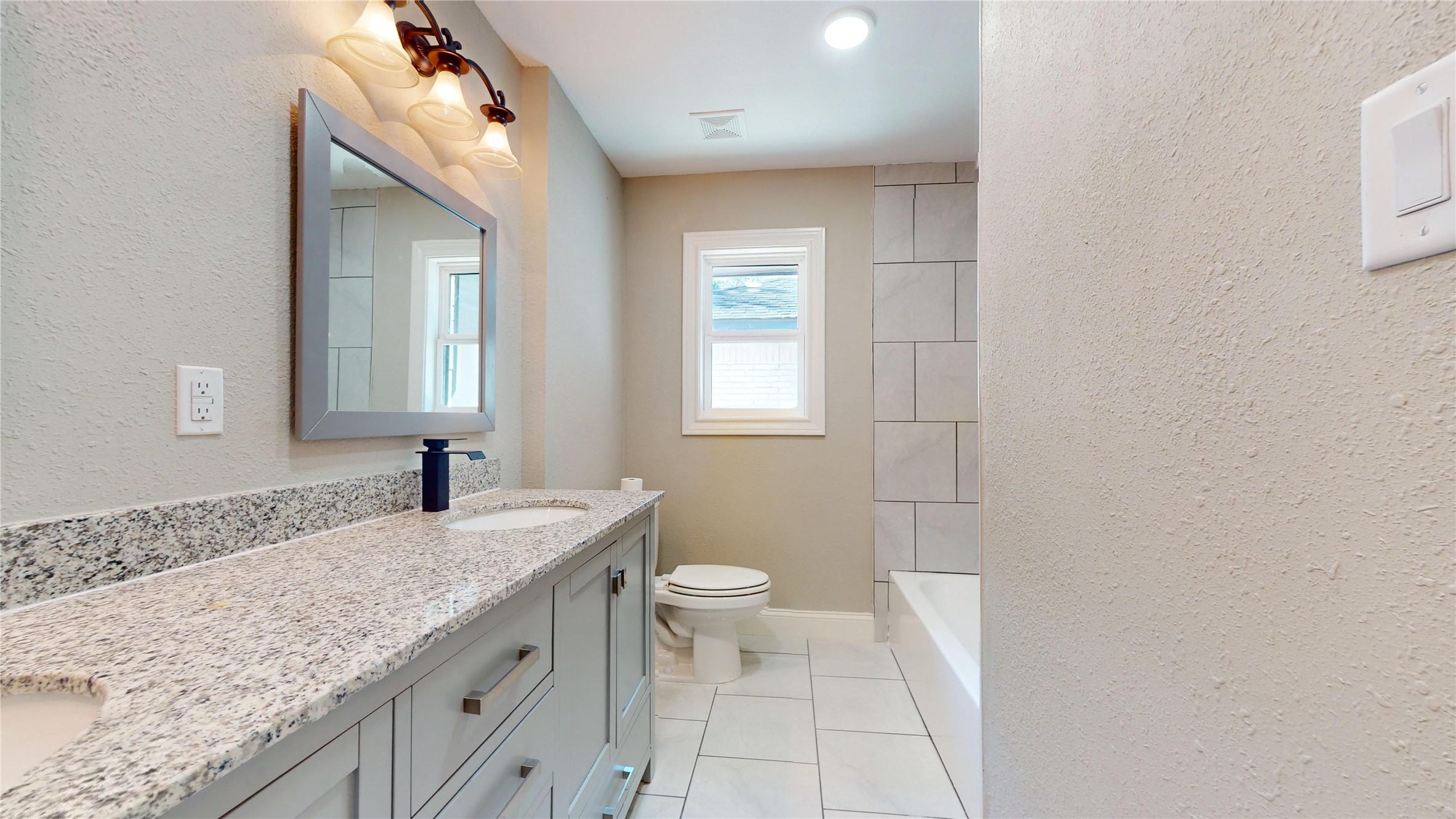 603 Maple Way Houston, TX 77015 - Photo 16 of 35 a bathroom with a granite countertop sink toilet and mirror