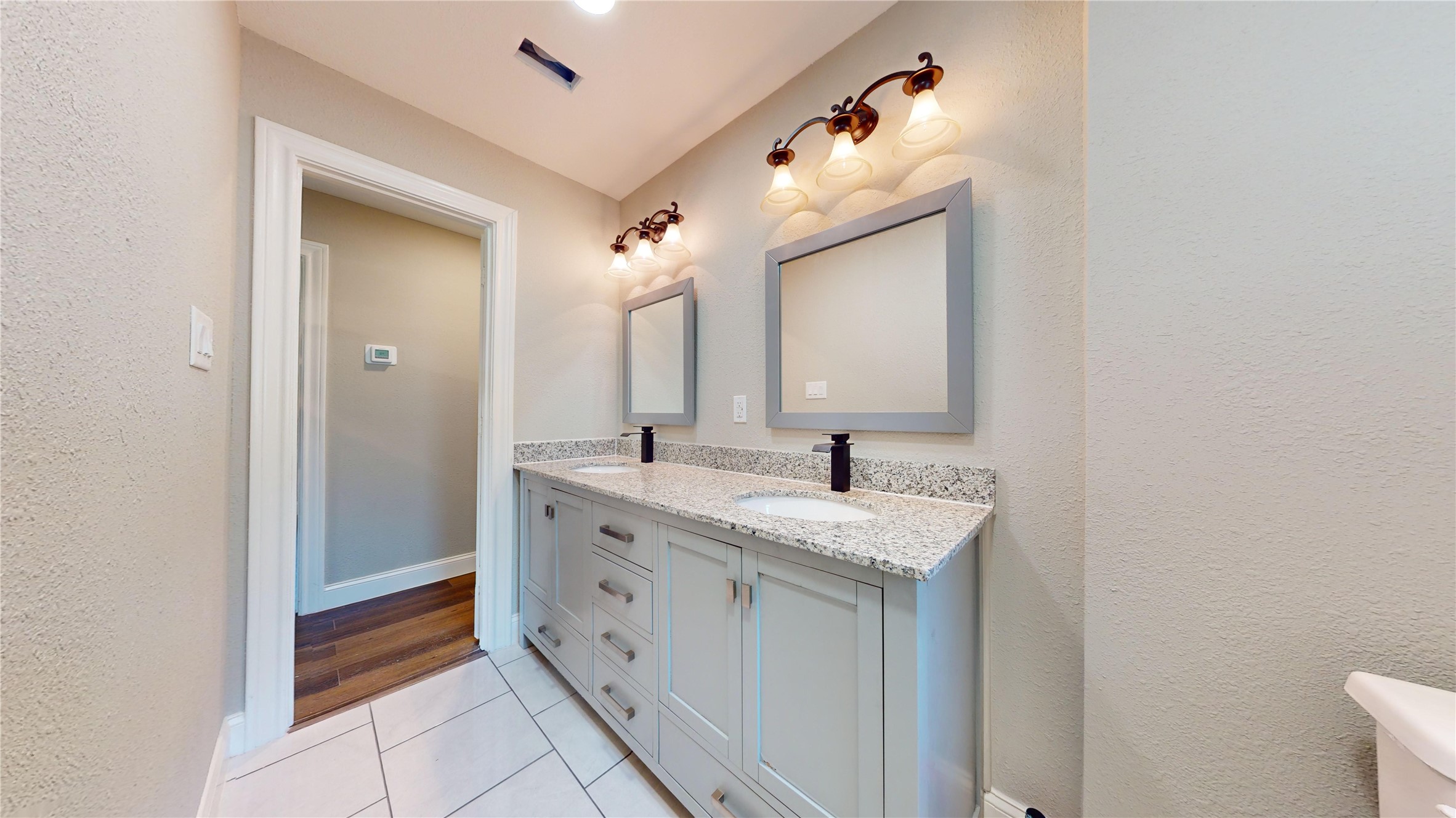 603 Maple Way Houston, TX 77015 - Photo 18 of 35 a spacious bathroom with a double vanity sink and mirror