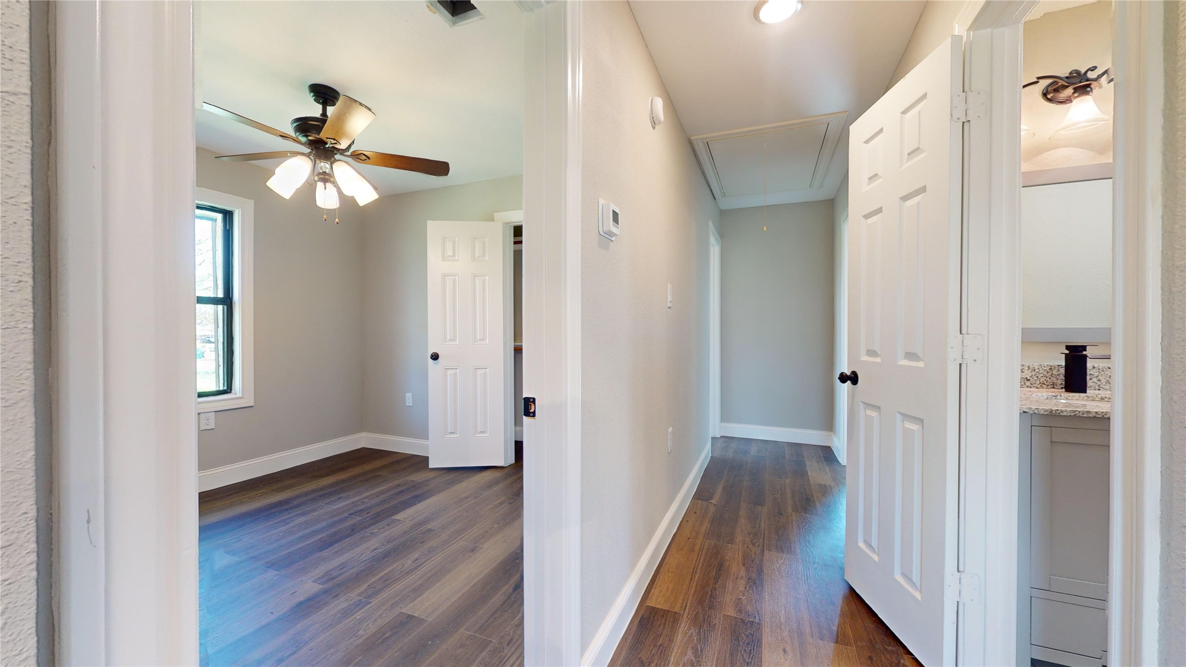 603 Maple Way Houston, TX 77015 - Photo 10 of 35 a view of a hallway with wooden floor and a ceiling fan