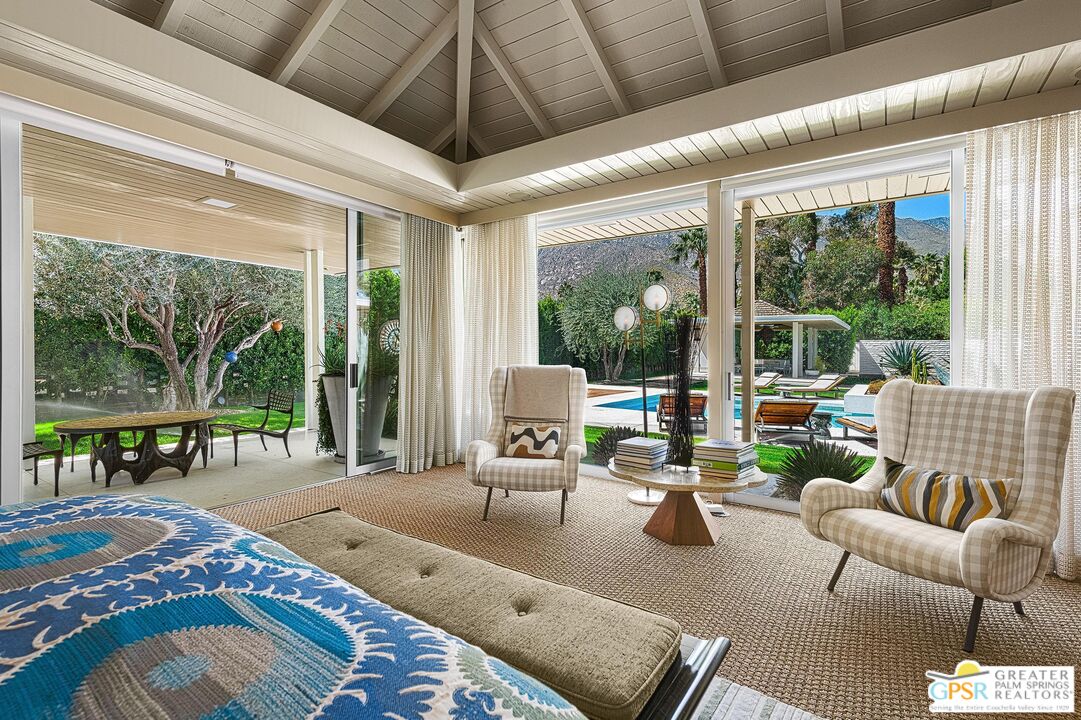 611 North Phillips Road Palm Springs, CA 92262 - Photo 6 of 10 a living room with patio furniture and a floor to ceiling window