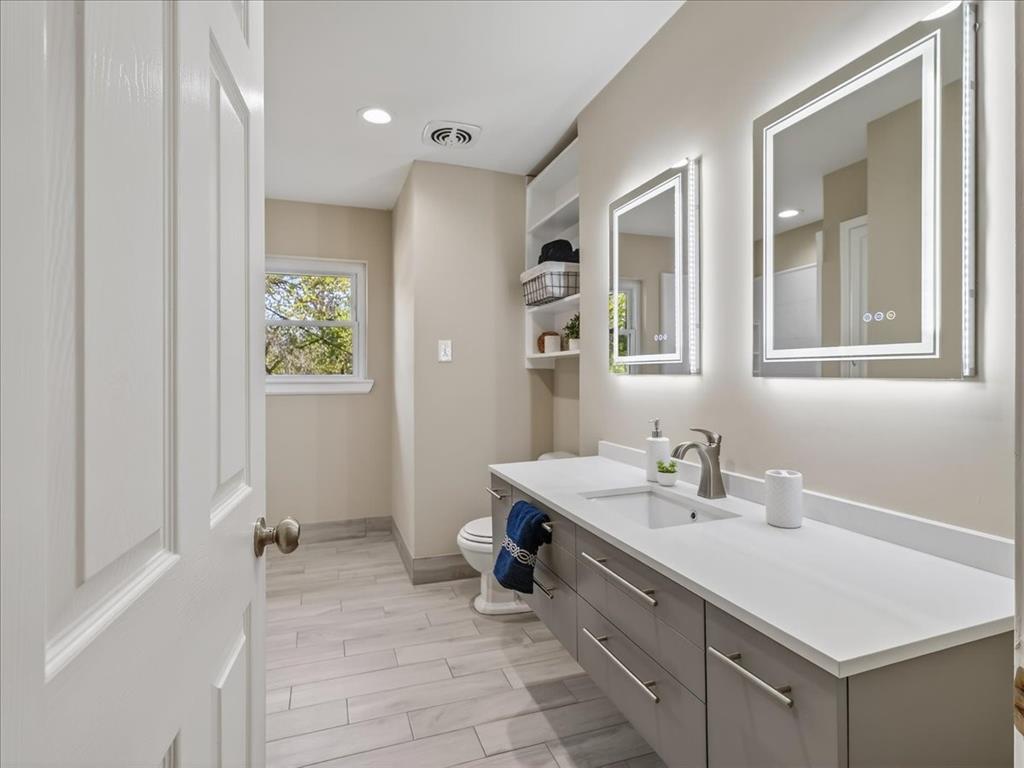 3863 Clayton Road East Fort Worth, TX 76116 - Photo 29 of 39 a bathroom with a sink vanity and a mirror