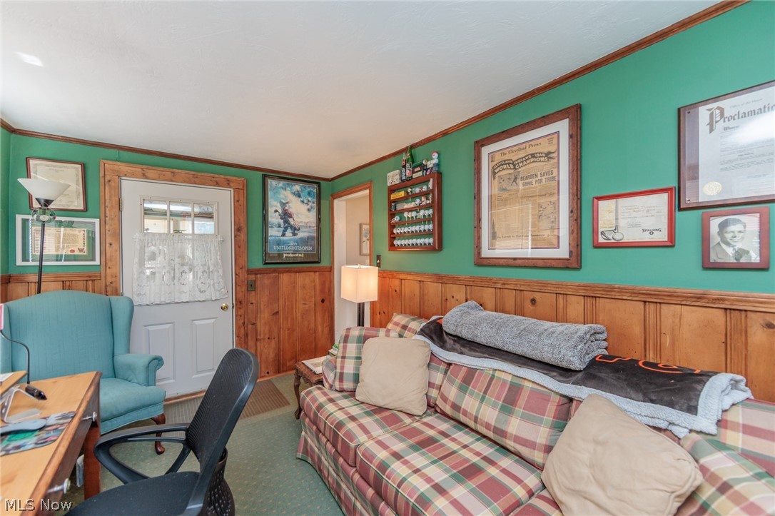 5364 Summit Road Lyndhurst, OH 44124 - Photo 7 of 42 Interior space featuring a white paneled door with glass inserts, wood paneling, green painted walls, and wood-finish trim
