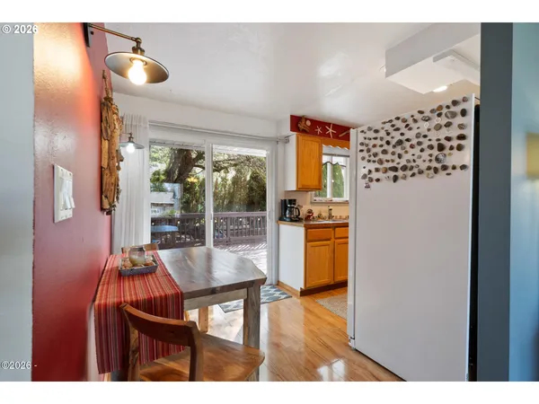 a dining room with furniture and wooden floor