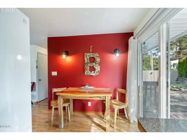 a view of a room with furniture and wooden floor