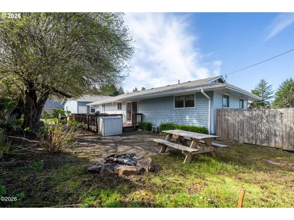 a backyard of a house with yard barbeque oven and outdoor seating