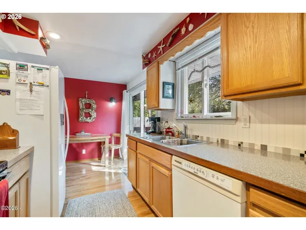 a kitchen with stainless steel appliances granite countertop a sink and cabinets