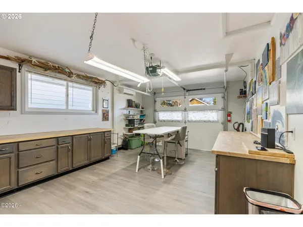 a kitchen with a sink cabinets and wooden floor