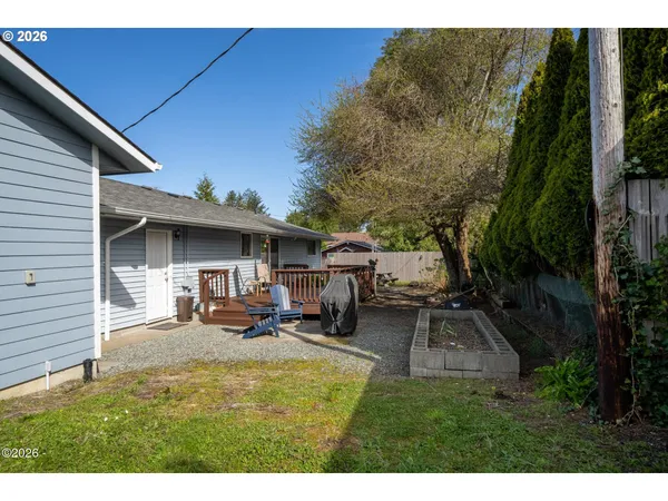 a view of a backyard with table and chairs and potted plants