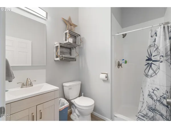 a bathroom with a sink vanity mirror and toilet